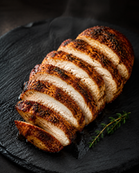 HiPro roasted chicken breast taster — Cajun, sliced to show real grain