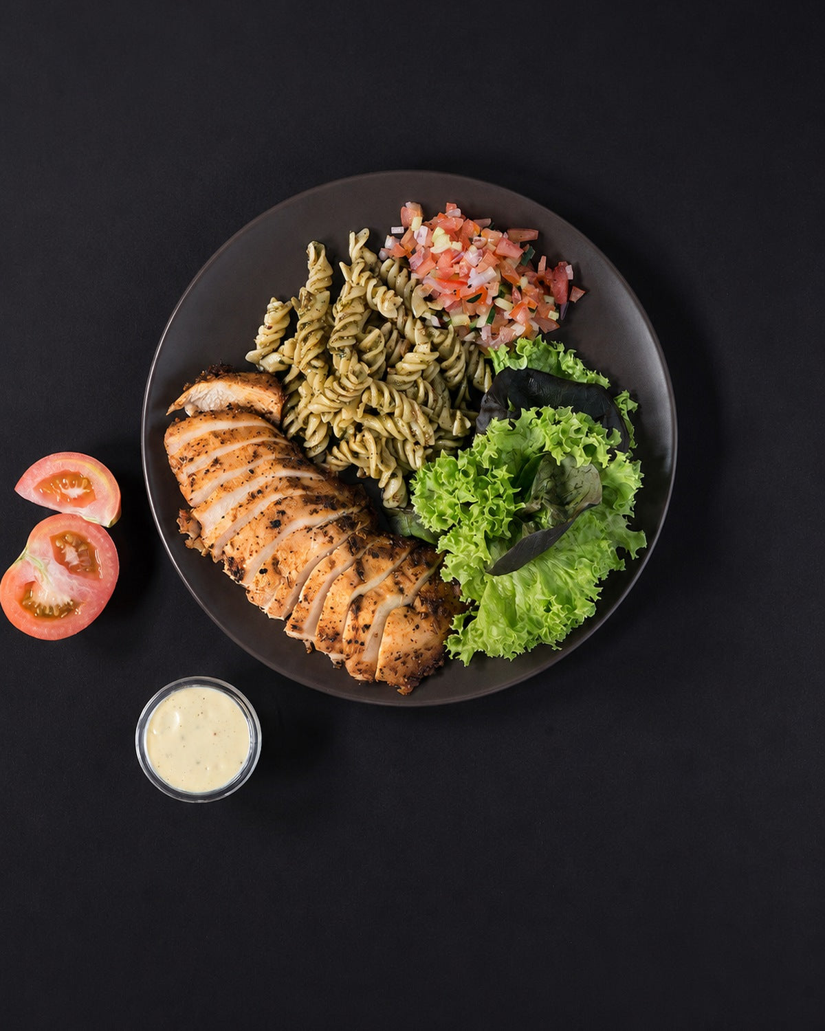 The full plate: Cajun-roasted chicken breast with pesto fusilli, tomato salsa and lettuce. Serving suggestion; the box is the chicken only.