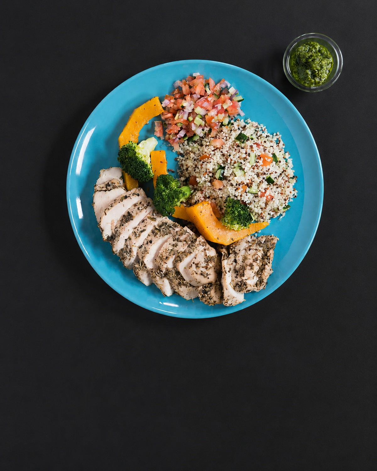 The full plate: Italian herb-roasted chicken breast with couscous salad, roasted vegetables and a pot of pesto. Serving suggestion; the box is the chicken only.